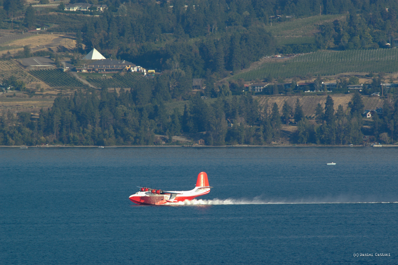 September 1st, 2003 - 17:58 PST The Martin Mars waterbomber was scooping in the middle of Okanagan Lake with the Summerhill Winery Pyramid in the background.